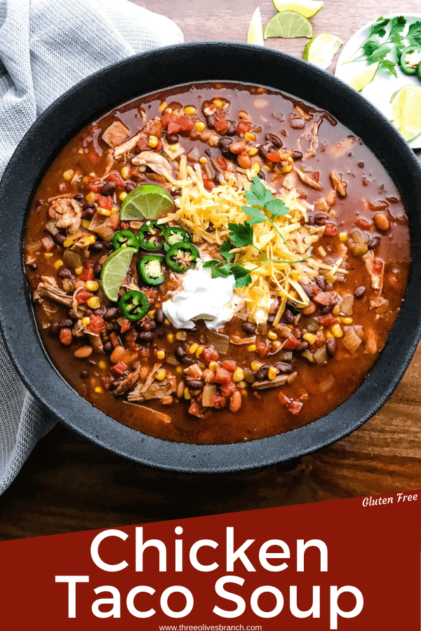 Pin image of Chicken Taco Soup in a black bowl on a wood table with title at bottom