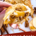 Pin of a hand holding a cracker topped with Cinnamon Apple Baked Brie in Puff Pastry and title at bottom