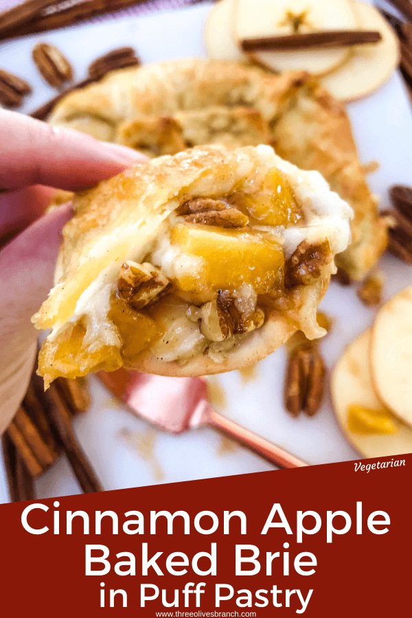 Pin image of Cinnamon Apple Baked Brie in Puff Pastry on a cracker being held with title at bottom