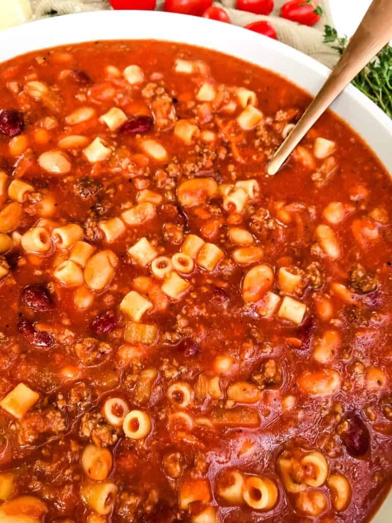 Large bowl of Copycat Olive Garden Pasta Fagioli Soup with a spoon