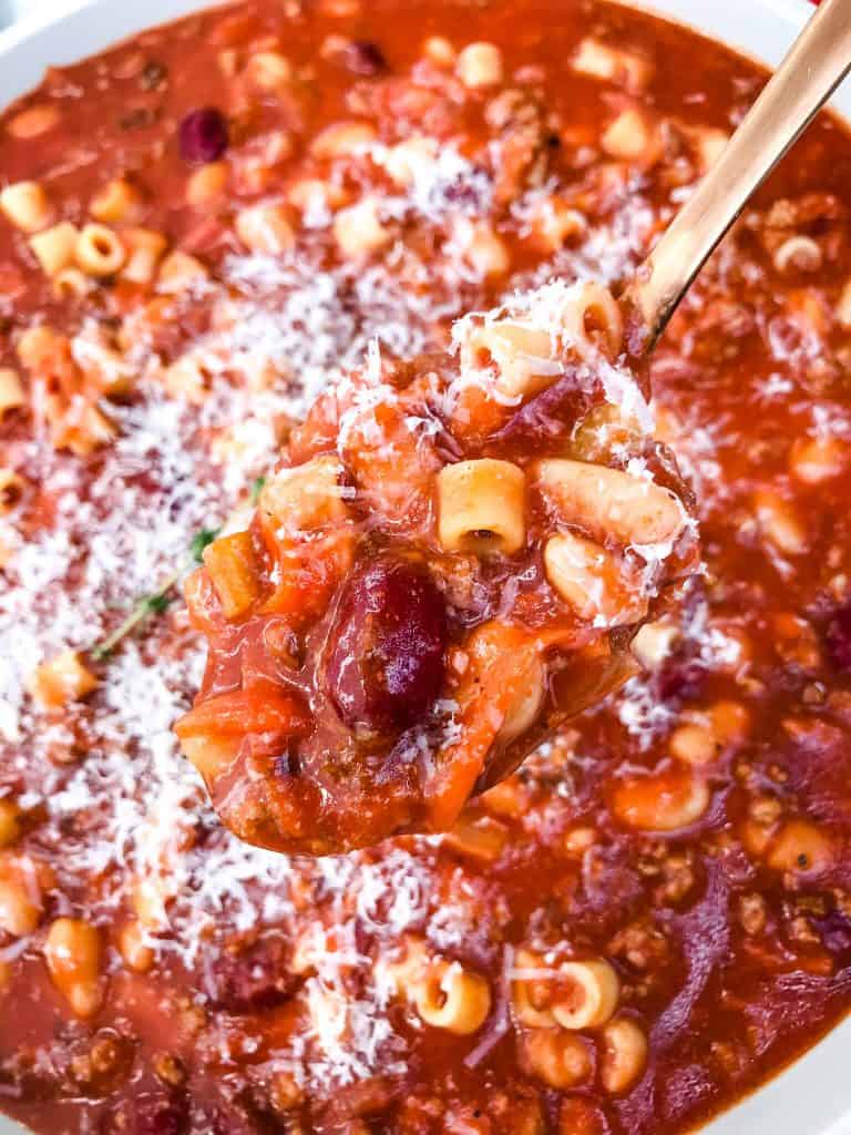 A spoon scooping Copycat Olive Garden Pasta Fagioli Soup out of a bowl