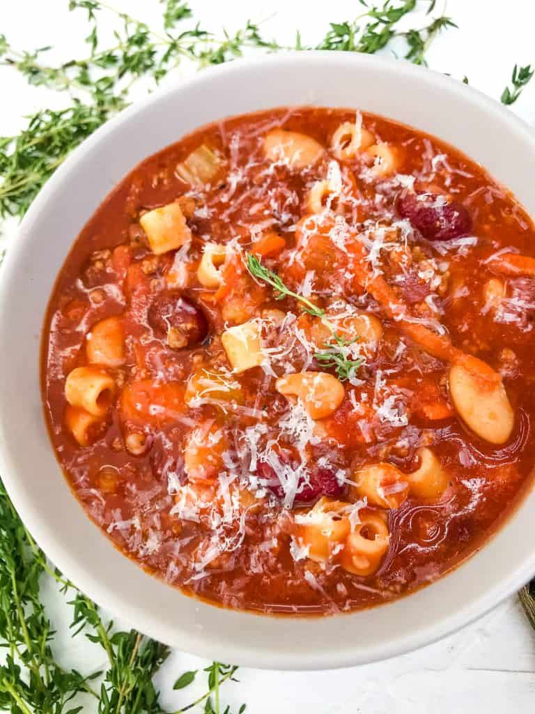 A bowl of Copycat Olive Garden Pasta Fagioli Soup with Parmesan cheese on top