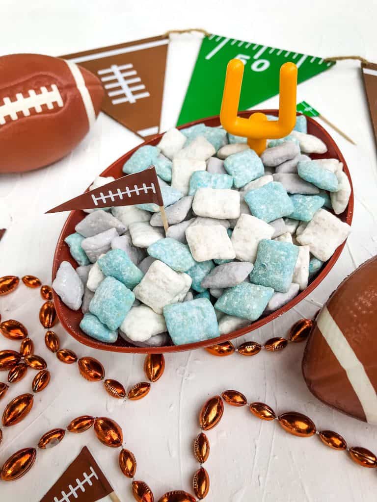 Blue, gray, and white, dessert Chex surrounded by football items
