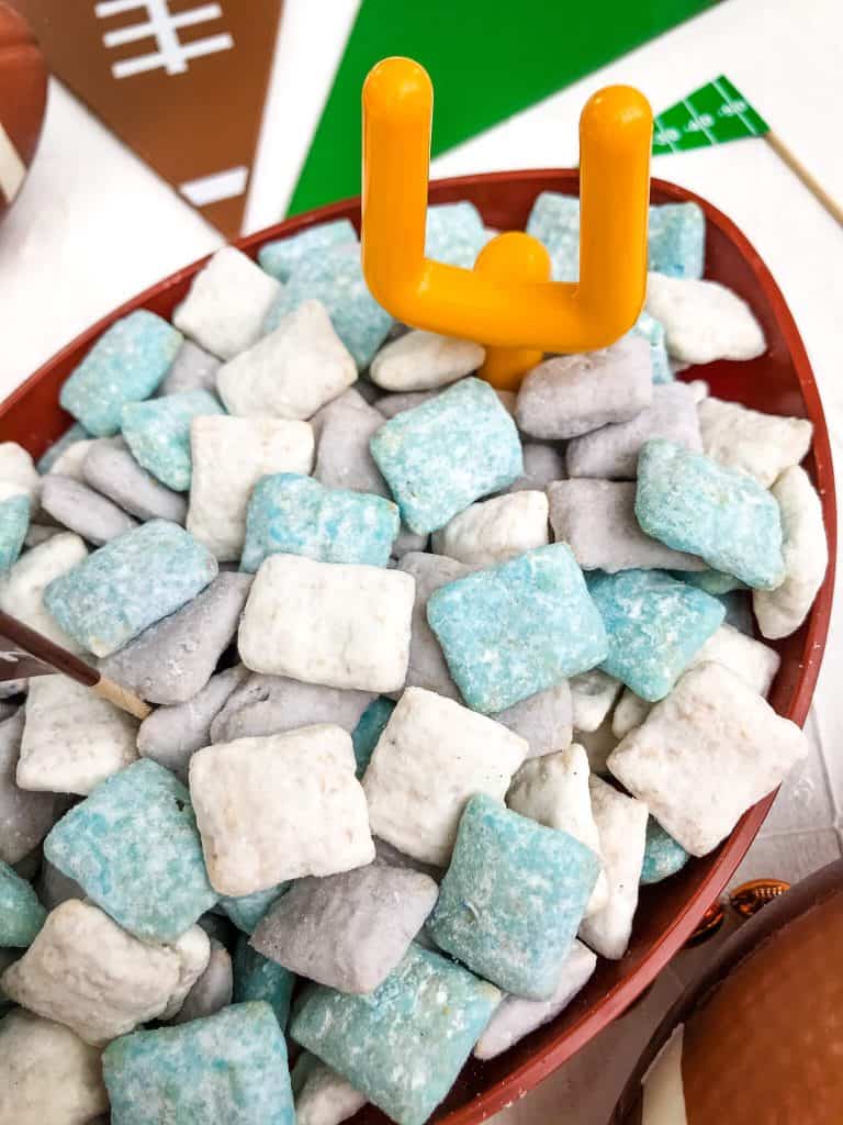 Light blue, gray, and white muddy buddies in a bowl with a small goalpost