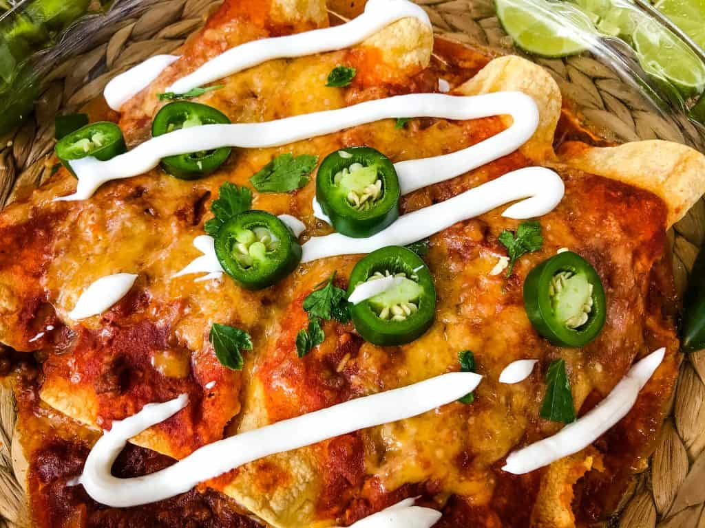 Beef enchiladas in a dish with toppings