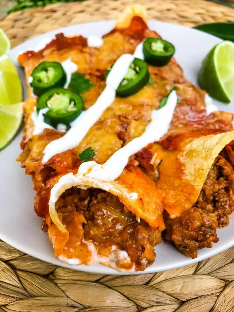 Filling of Ground Beef Enchiladas peeking out of the end of the enchilada