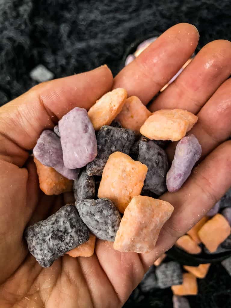 A hand holding Halloween Puppy Chow