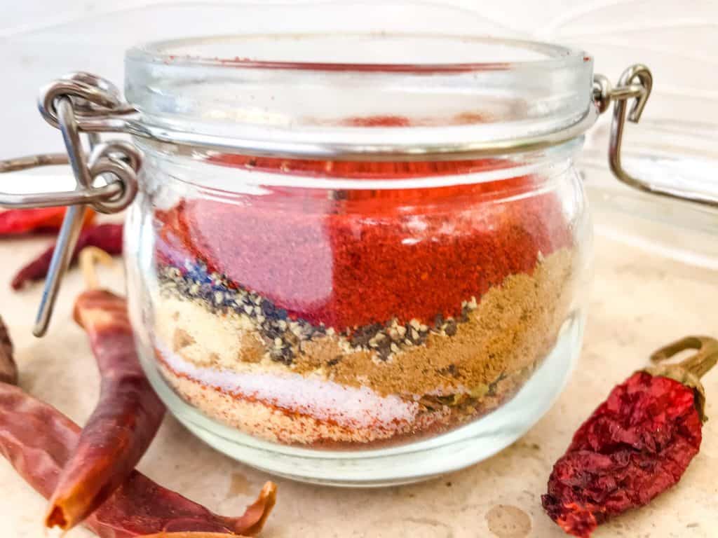 A clear jar that you can see the layered spices in