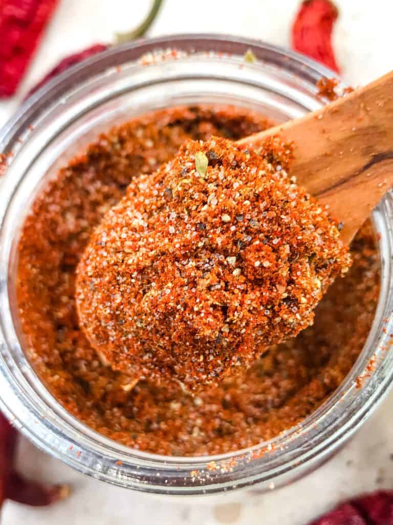 A wood spoon scooping Homemade Taco Seasoning