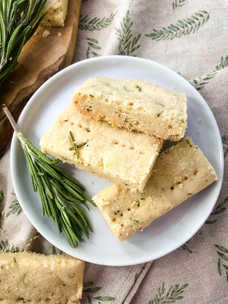 Olive Oil Rosemary Shortbread on a small plate with a rosemary branch