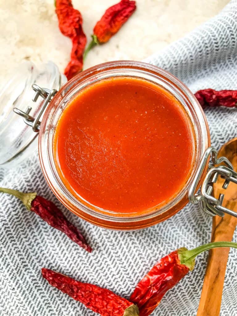 Red Enchilada Sauce Recipe on a towel with wooden spoon