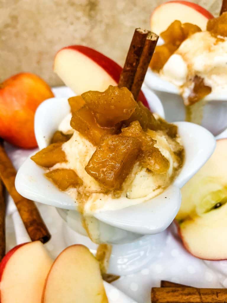 Cinnamon Apple Dessert Sauce poured on top of vanilla ice cream in a bowl