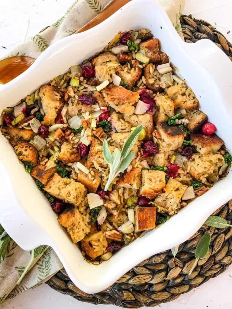 Top view of Thanksgiving Stuffing with Cranberries, Kale, Pecans, and Wild Rice in a white square dish