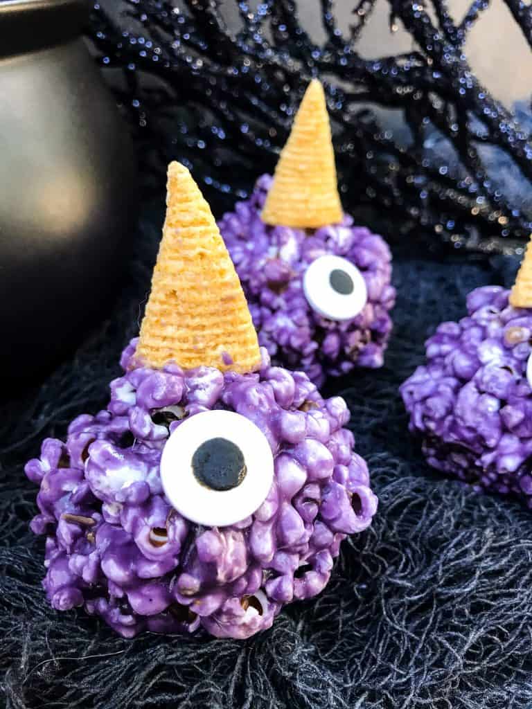 A purple popcorn ball with a horn and large eye sprinkle