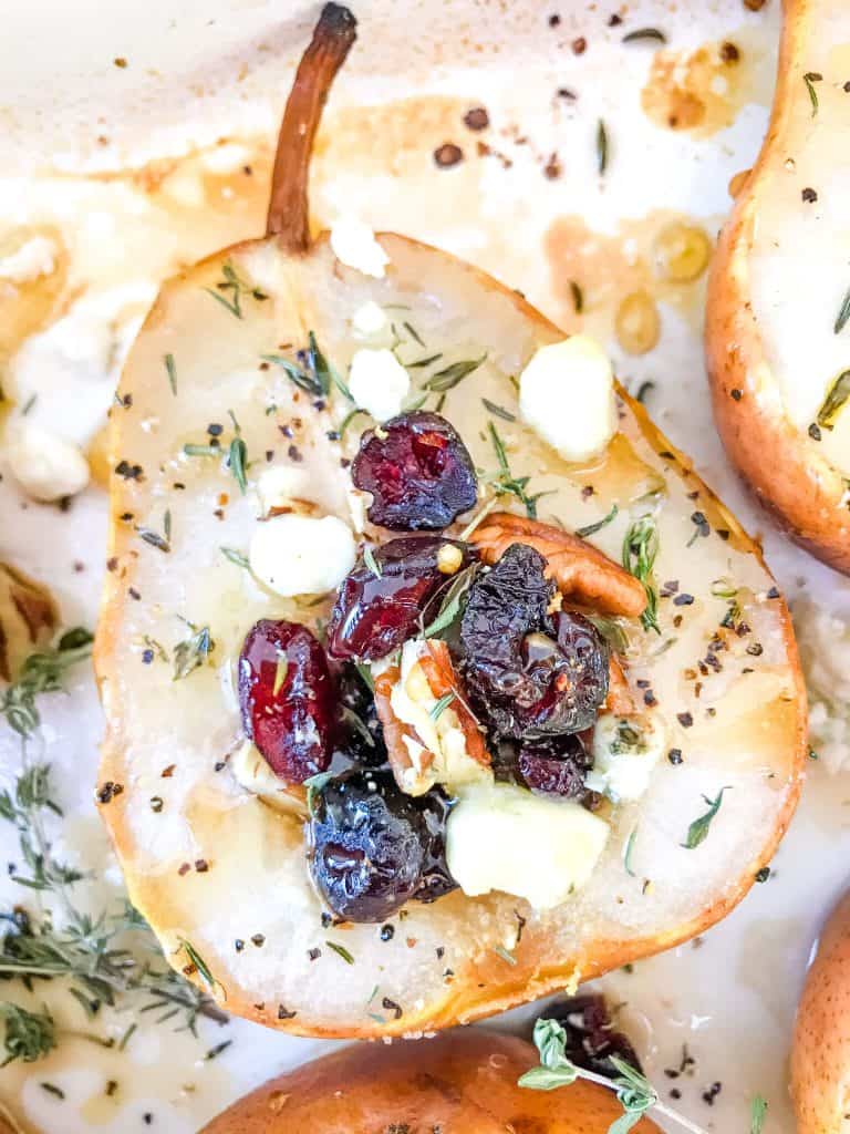 A close up of a Savory Baked Pears with Gorgonzola, Walnuts, and Cranberries