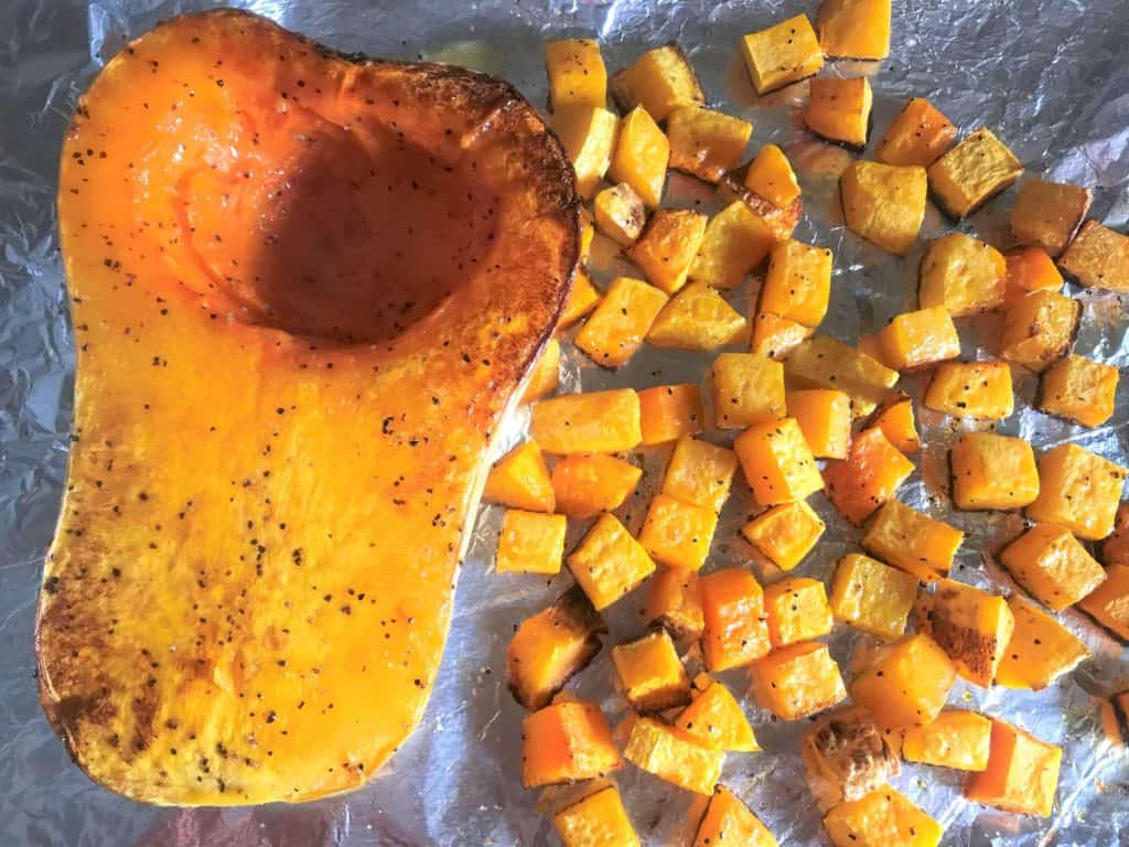 Squash being roasted on a baking sheet