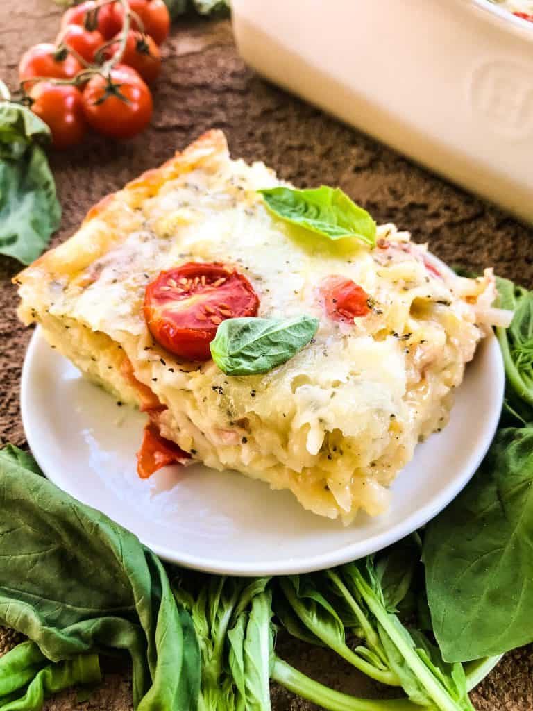 A portion of Caprese Hashbrown Breakfast Casserole on a small plate