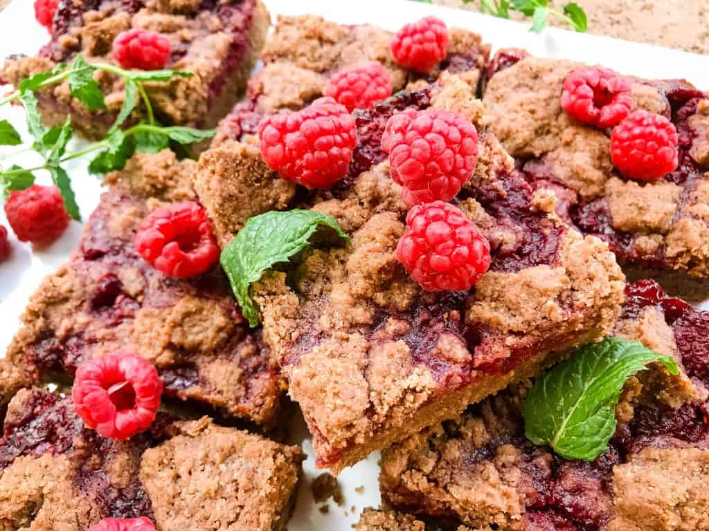Chocolate Raspberry Crumble Bars stacked on a white tray