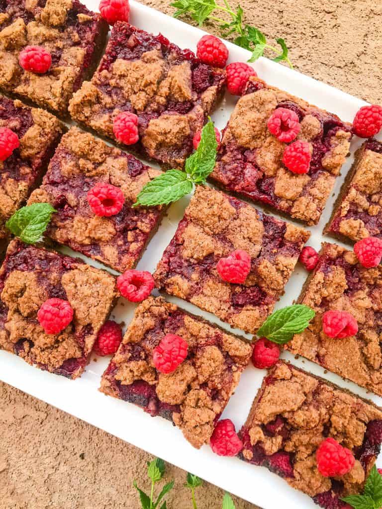 The cookie bars on a white tray with mint