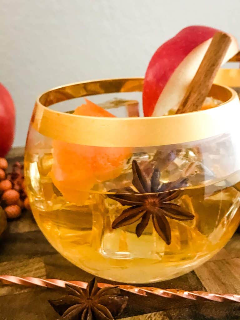 A close up of a Cinnamon Apple Old Fashioned in a glass