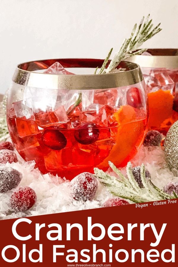 Pin image for Cranberry Old Fashioned Cocktail with red cocktail in round glass with silver rim and title at bottom