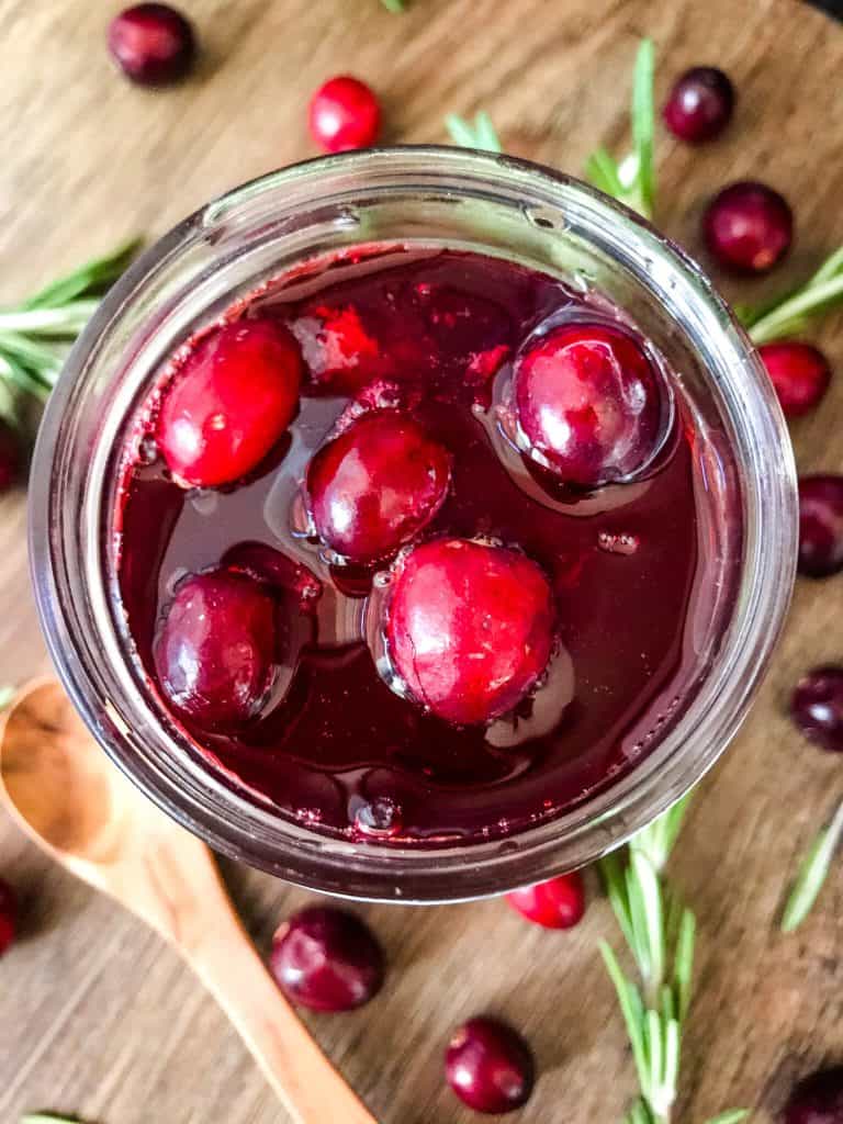 Top view of Cranberry Simple Syrup with some berries floating on top