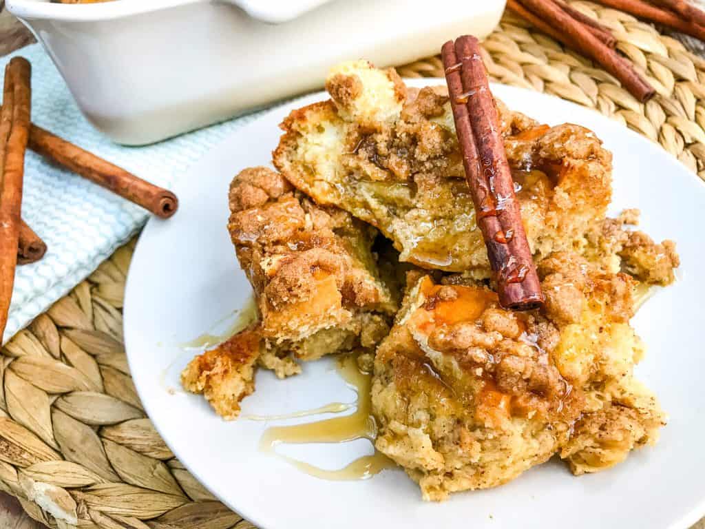 A plate with French toast and a cinnamon stick