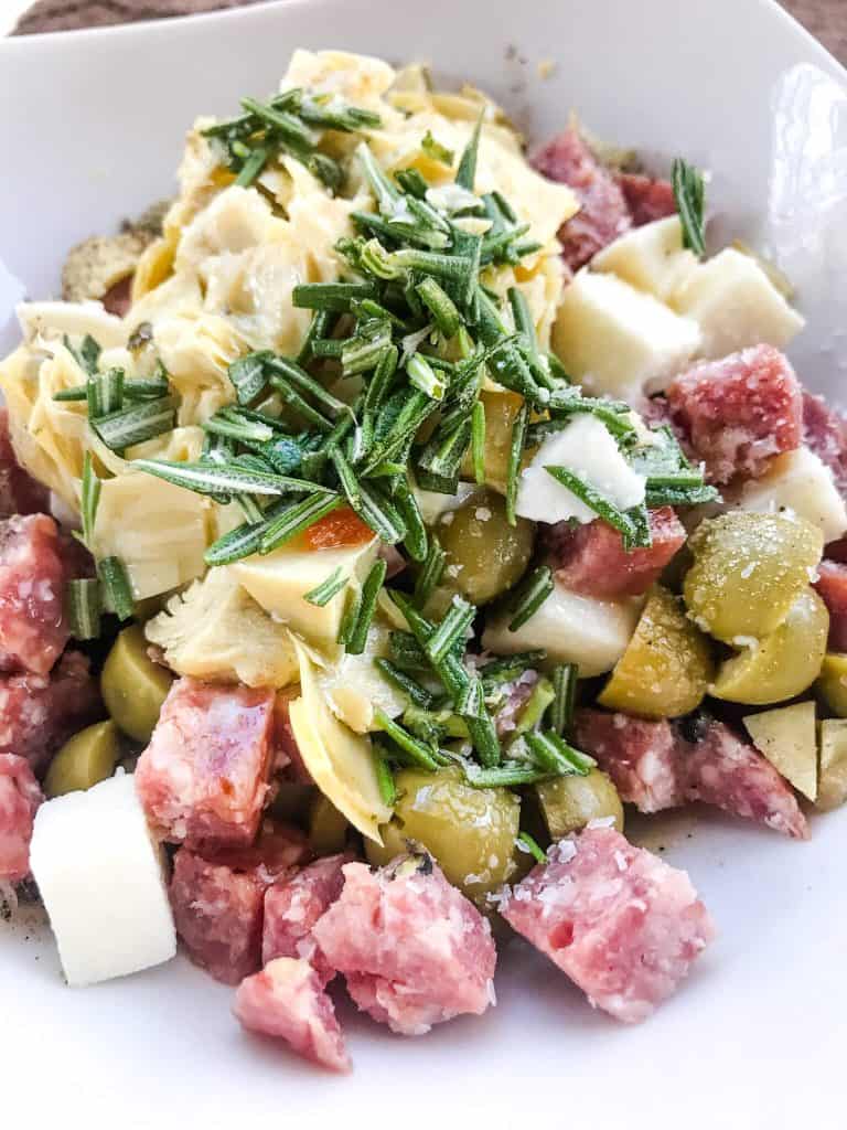 The antipasti ingredients all piled in a bowl