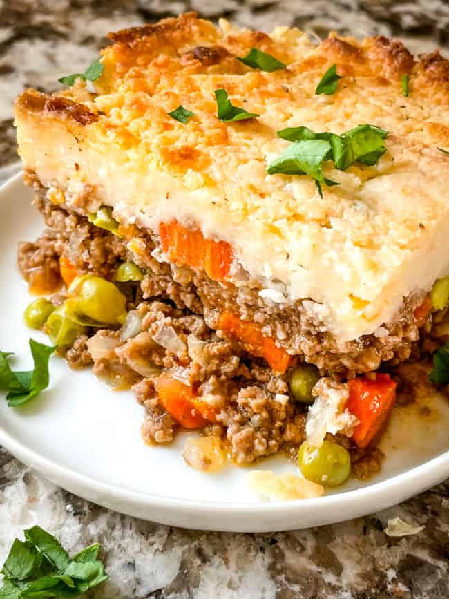 A portion of the Guinness Shepherd's Pie from the side on a white plate