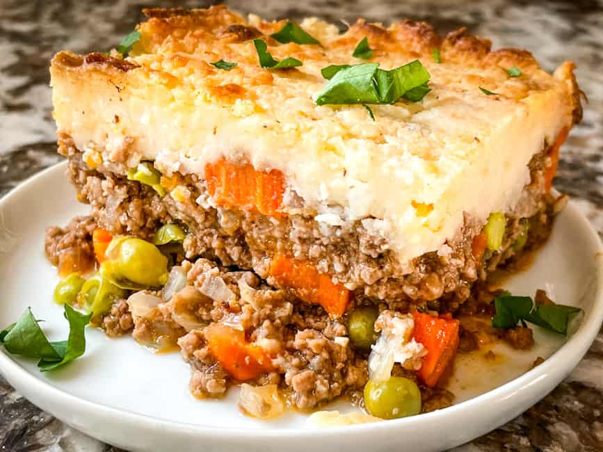 A portion of Guinness Shepherds Pie on a small round white plate