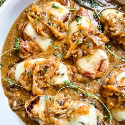 French Onion Pork Chops with the sauce in a large serving dish