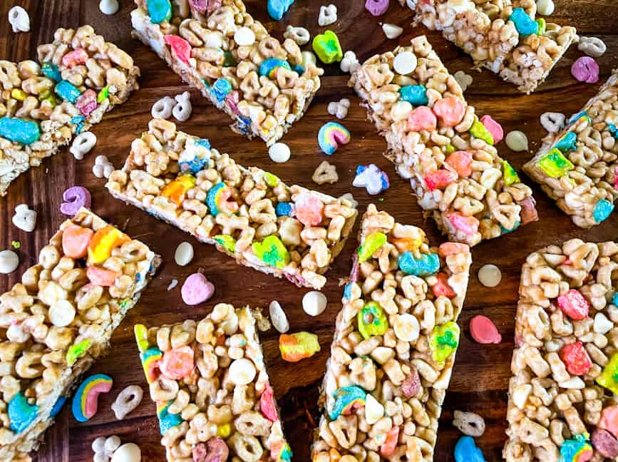 Lucky Charms Cereal Bars scattered on a wood surface