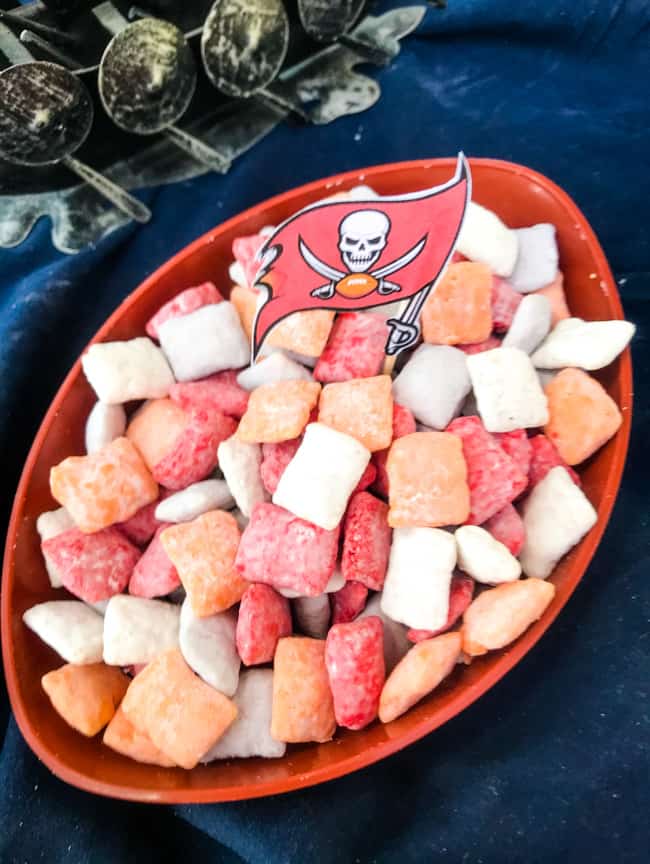 A bowl of colored muddy buddies with the team flag