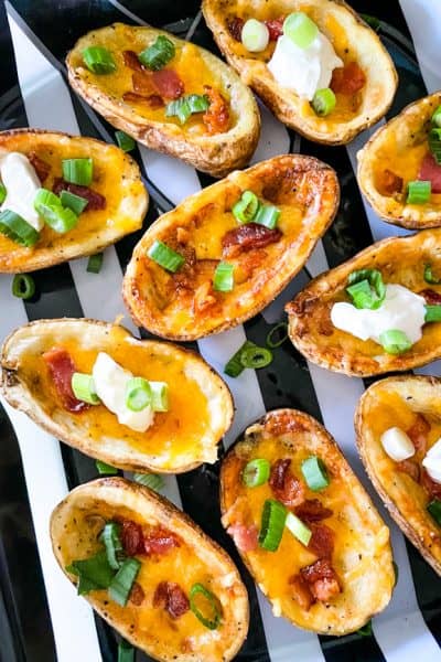 Air Fryer Potato Skins filled with bacon, cheese, sour cream, and chives