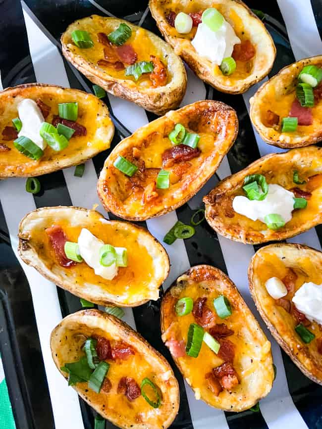 Air Fryer Potato Skins filled with bacon, cheese, sour cream, and chives