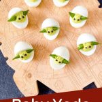 Pin image for Baby Yoda Deviled Eggs on a cutting board with title at bottom