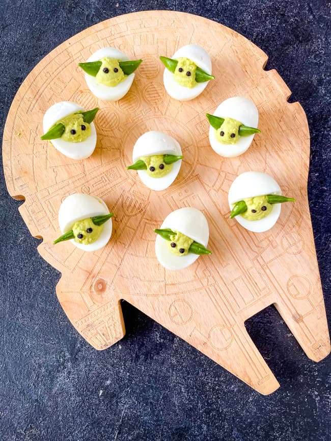 The eggs spread out on a spaceship cutting board