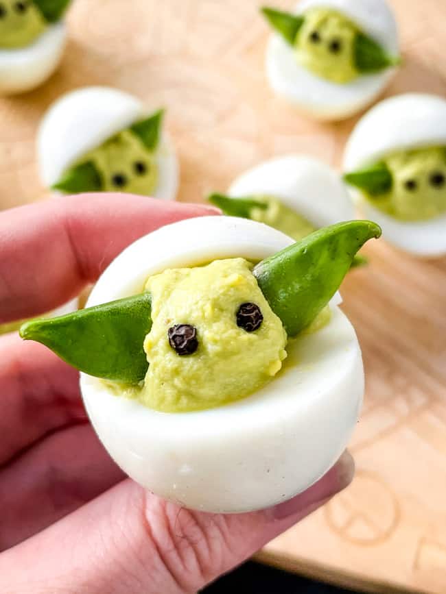 A hand holding a Baby Yoda Deviled Egg