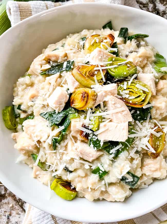 Creamy rice with vegetables in a white bowl