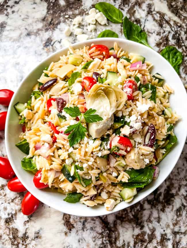 A white bowl full of Greek Orzo Salad from the top