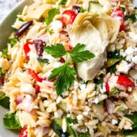 A bowl of Mediterranean vegetables mixed with the pasta and spinach