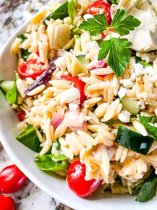 Close up of orzo pasta salad with Mediterranean vegetables