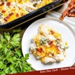 Pin image of Keto Chicken Bacon Ranch Casserole on a plate next to the serving dish with title at bottom