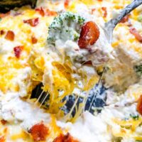 A spoon scooping Keto Chicken Bacon Ranch Casserole out of the dish