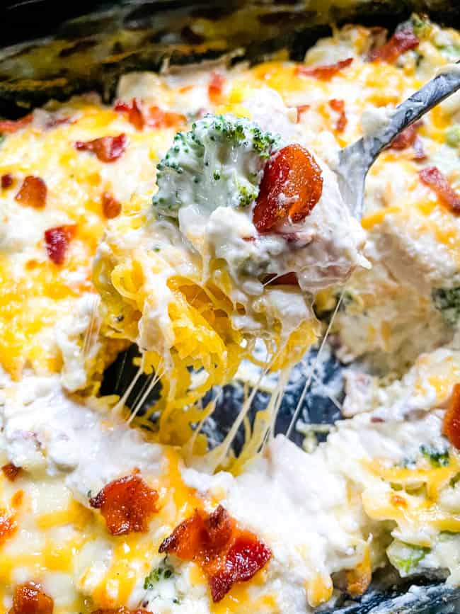 A spoon scooping Keto Chicken Bacon Ranch Casserole out of the dish