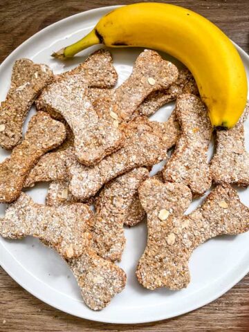 A white plate stacked with Banana Dog Treats and a banana