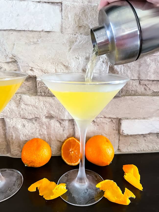 A Orange Martini being poured into a frosted glass