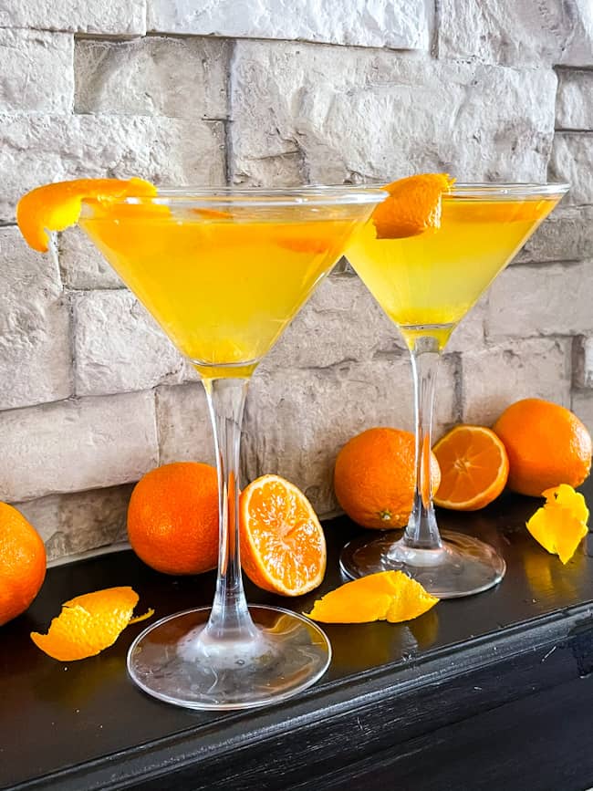 Two Orange Martinis with oranges around them