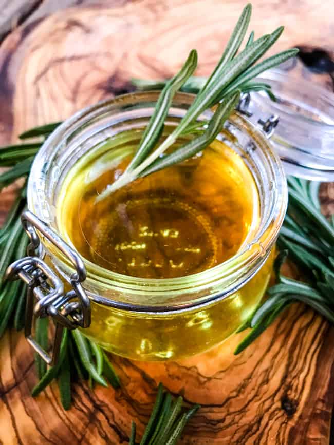 A clear jar on a wood board filled with the sweet condiment