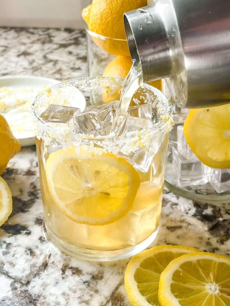 A shaker pouring a Lemon Margarita into a glass